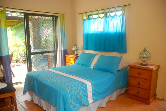 Bedroom at Aromas with sliding doors out to the veranda