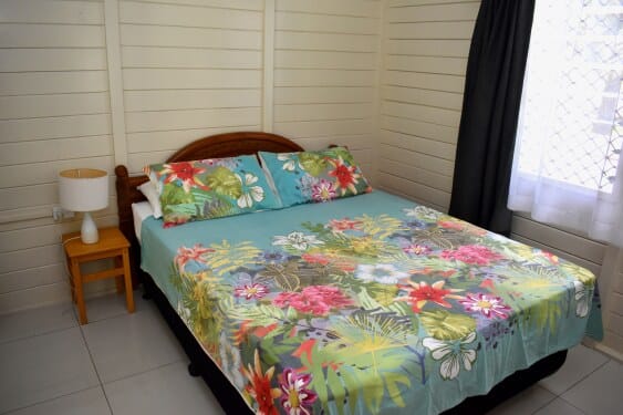 master bedroom with queen size bed at MAcs Shack