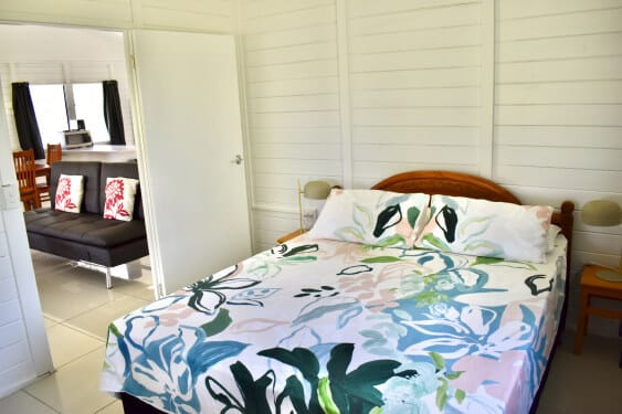 master bedroom with queen size bed at MAcs Shack