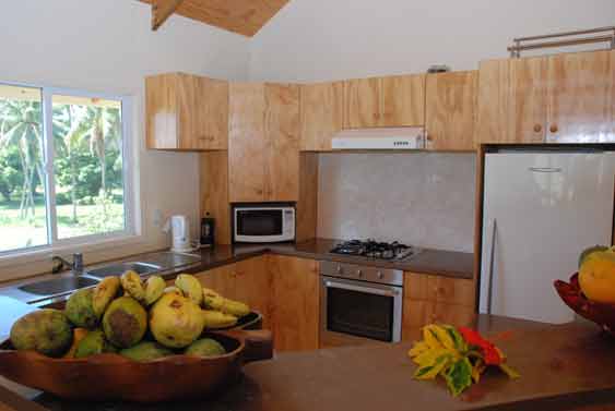 The kitchen is modern and spacious with a breakfast bar attached to it