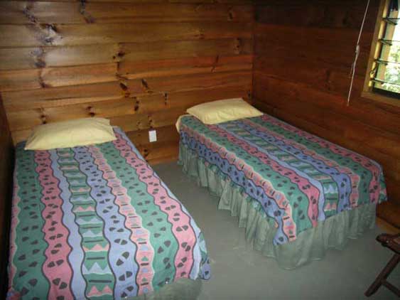 Second bedroom with two single beds at Nikao Cottage, Rarotonga, Cook Islands