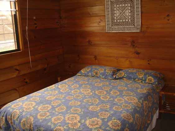 Main bedroom with queen size bed at Nikao Cottages, Rarotonga, Cook Islands