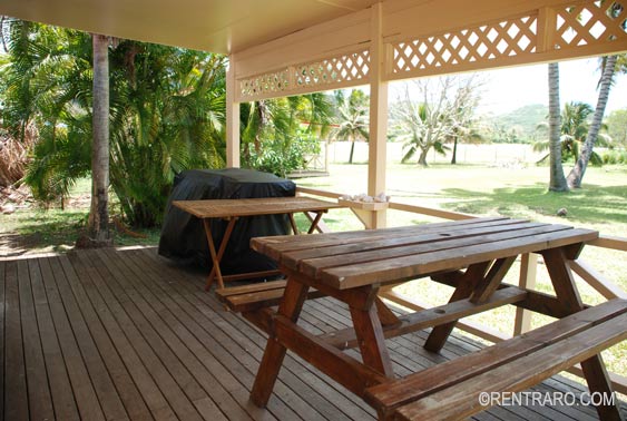 covered deck where there are outside table and chairs to enjoy alfresco dining