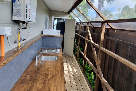 back of home with bench and bathroom